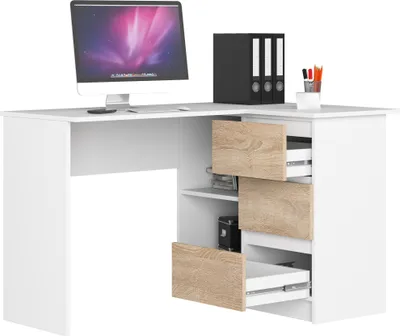 A white corner desk with wood-tone drawer fronts and shelves, featuring a computer monitor, binders, and pens.
