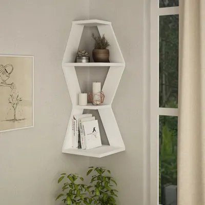 A white corner shelf unit with decorative items and books.