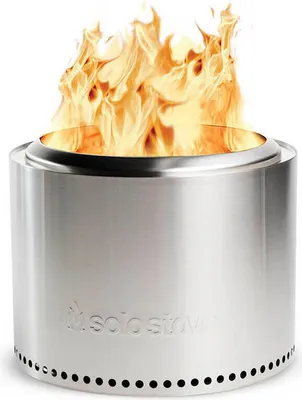 A stainless steel Solo Stove Bonfire with flames burning inside, set against a white background.