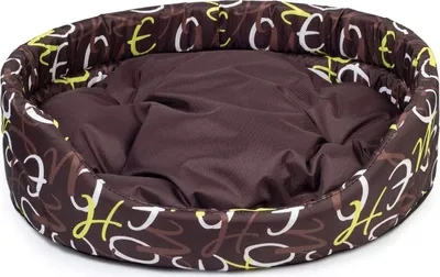 A brown oval dog bed with a pattern of white and yellow letters on a white background.