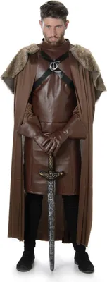 A man dressed in a medieval-style costume, holding a sword.