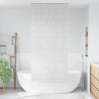 A modern bathroom with a freestanding bathtub and a shower curtain.