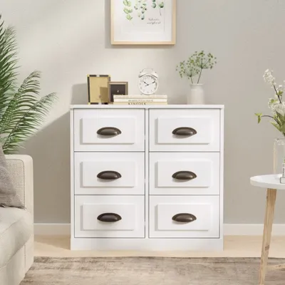 A white dresser with six drawers is shown in a well-lit room.