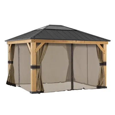 A gazebo with wooden posts and a dark roof, featuring sheer curtains and mosquito netting.