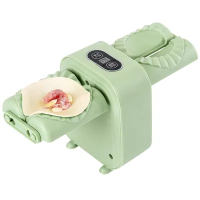 A light green automatic dumpling maker with a piece of dough and filling on one side.