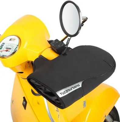 A close-up shot of black hand covers attached to the handlebars of a yellow scooter.