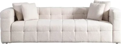 A studio shot of a beige sofa with throw pillows.