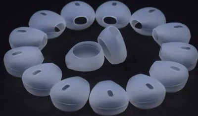 A collection of silicone earbud tips arranged in a circular pattern on a black background.