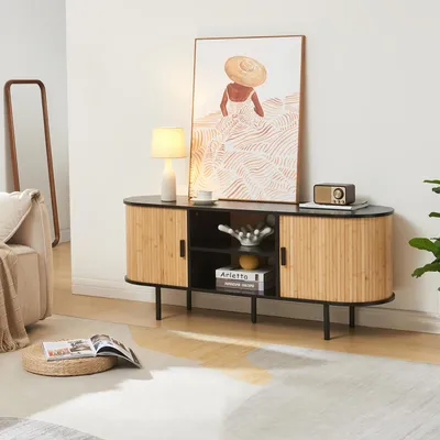 A living room scene featuring a TV stand with decorative items and artwork.