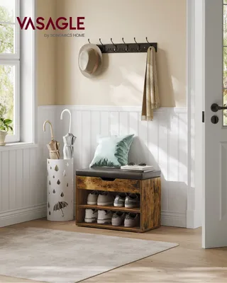 An entryway with a shoe bench, coat rack, and umbrella stand.