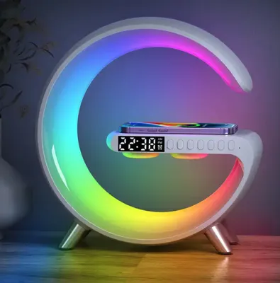 A modern, curved LED lamp with a built-in wireless charger and digital clock, displaying a rainbow of colors.