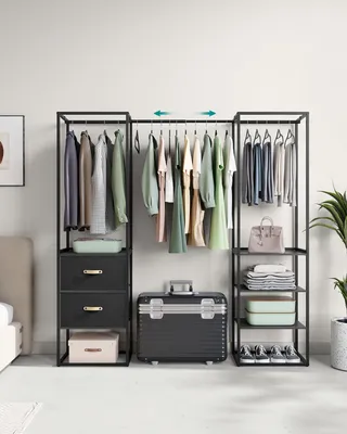 A modular closet system with clothes hanging on racks and items stored in drawers and on shelves, with a suitcase in front.