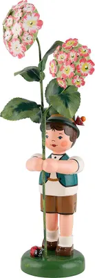 A wooden figurine of a boy holding a flower.