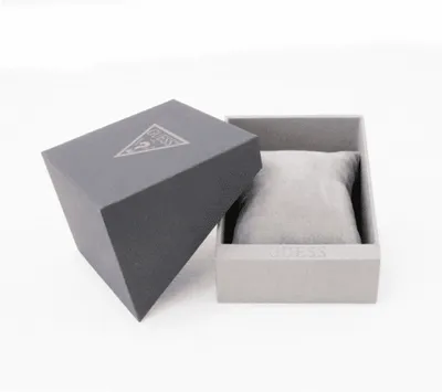An open Guess watch box with a grey cushion inside.