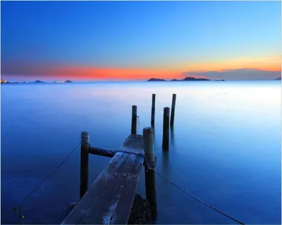 Produktbild von Wallario Poster - Steg im Wasser - Abendstimmung am Meer, Kunstdruck Größe: 40 x 50 cm