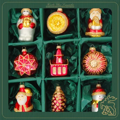 A box of nine Christmas tree ornaments, each in its own compartment.