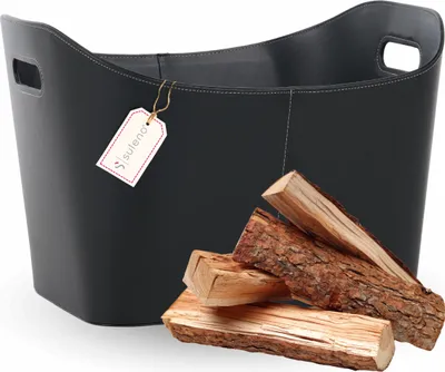 A black leather log basket with a tag and some firewood in front of it.