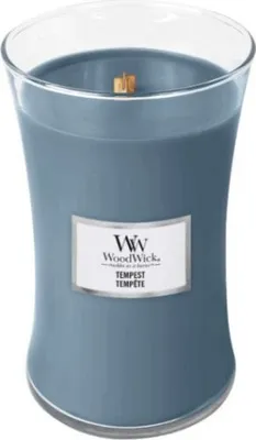 A close-up studio shot of a blue WoodWick candle in a glass jar.