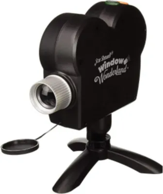 A black projector shaped like a vintage camera, mounted on a black tripod.