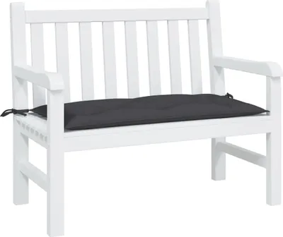 A white garden bench with a black cushion.
