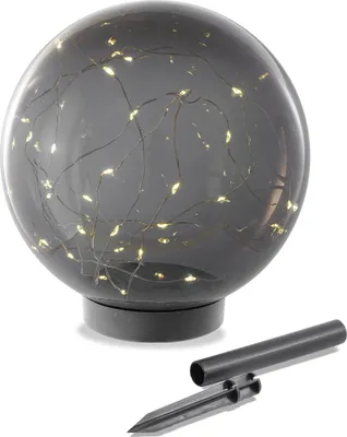 A solar-powered garden sphere with embedded LED lights and a ground stake.