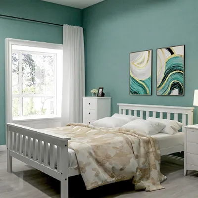 A bedroom scene with a white wooden bed and abstract artwork on the wall.