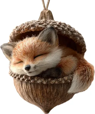 A close-up of a decorative ornament shaped like an acorn with a sleeping fox inside.