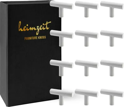 A black box with gold lettering sits next to a collection of white cabinet knobs.