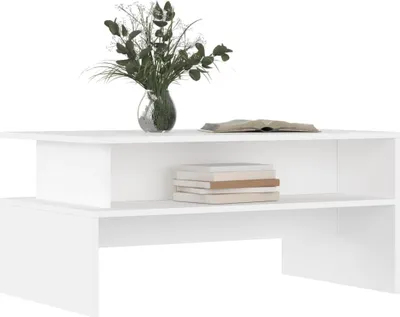 A white coffee table with a vase of flowers and books on it, set against a white background.