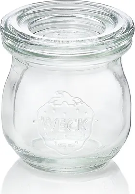 A clear glass jar with a strawberry embossed logo and the word "WECK" on the front, set against a white background.