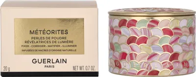 A product box and a decorative tin are shown side-by-side against a white background.