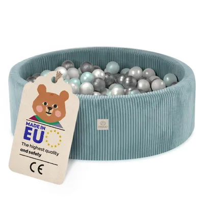 A blue corduroy ball pit filled with various colored balls, with a tag attached to the side.