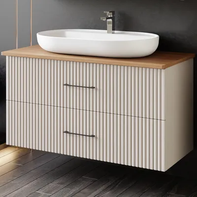 A modern bathroom vanity with a vessel sink and faucet.