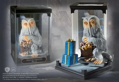 Two display cases containing a Demiguise figurine, one with a label and the other with gift boxes.