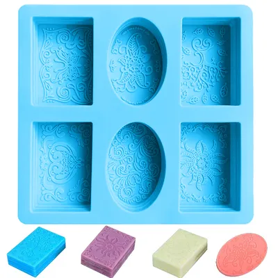 A blue silicone mold for making soaps or candles, with small samples of finished soaps shown below.