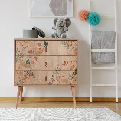 A child's room with a dresser, ladder, and stuffed elephant.