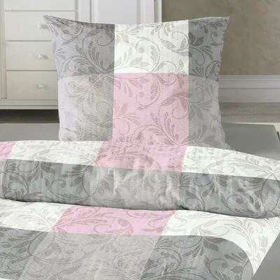 A close-up view of a pillow and duvet cover with a checkered pattern and floral design.
