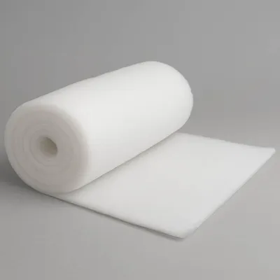 A roll of white, fluffy material is shown on a plain gray background.