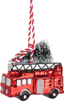 A Christmas ornament shaped like a red fire truck with a small Christmas tree on top, hanging from a red and white striped string.