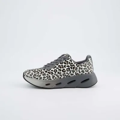 A single women's sneaker with a leopard print pattern is shown against a plain white background.