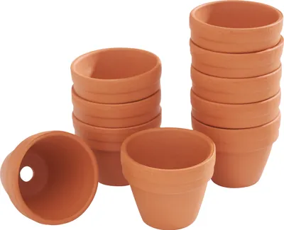 Several stacks of small terracotta pots are arranged on a white background.