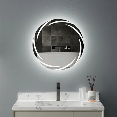 A modern bathroom vanity with a sink, faucet, and a round LED mirror with a decorative frame.
