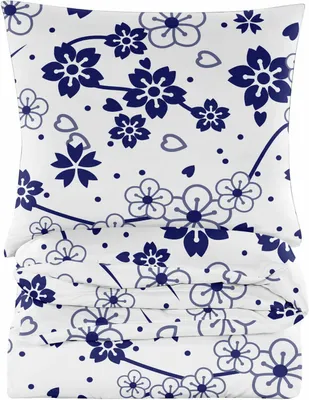 A stack of folded bedding with a floral pattern.
