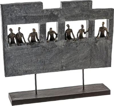 A sculpture of figures in windows on a stand.