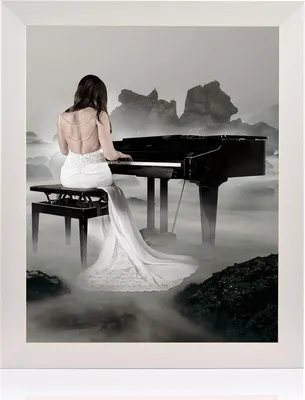A woman in a white dress plays a grand piano on a rocky, misty landscape.