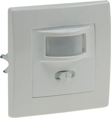A white wall-mounted motion sensor with a clear plastic lens and a small toggle switch.