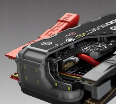 A close-up, cutaway view of a car jump starter, revealing its internal electronic components and wiring.