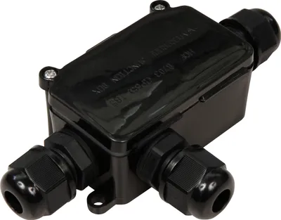 A black electrical junction box with three cable glands.