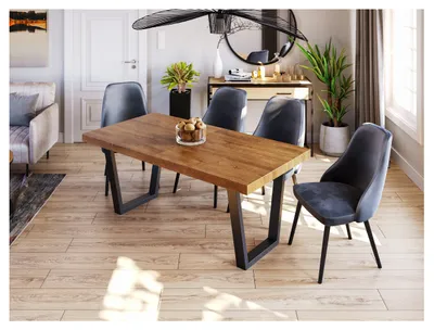 A dining room scene with a wooden table and chairs.