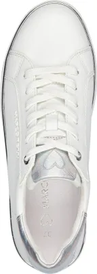 A top-down view of a white sneaker with silver accents.